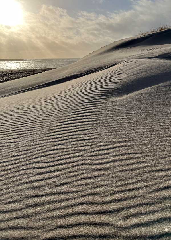 Sandets mønstre understøttes af den nedgående sols stråler